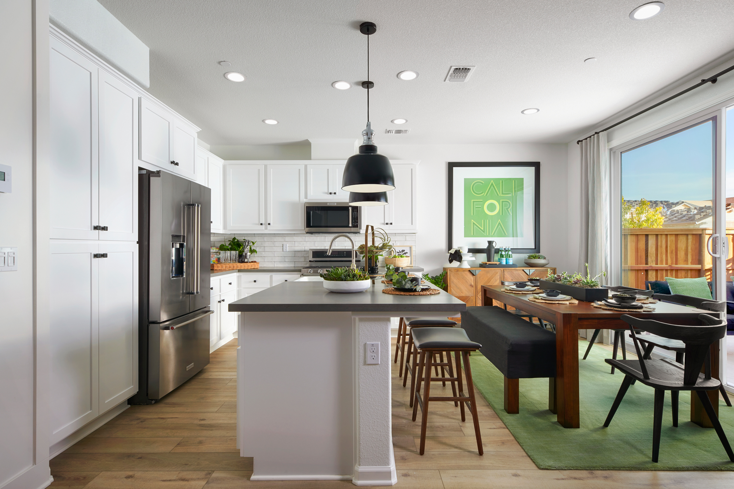 gourmet kitchen with island in model home at VanDaele